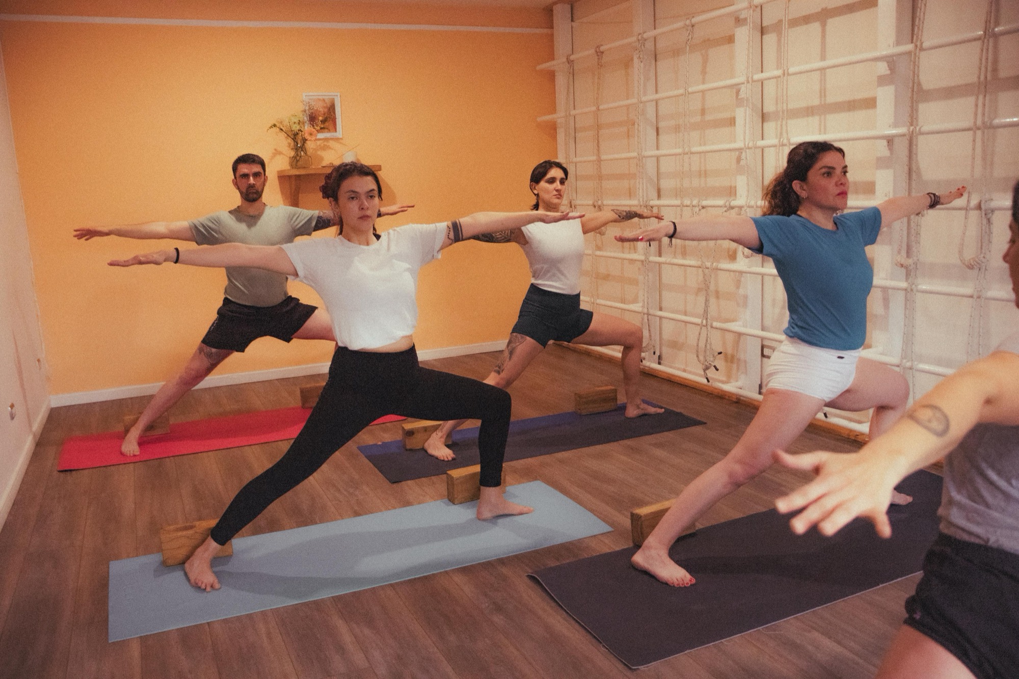 Práctica grupal de Virabhadrasana II en el shala